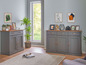Deux commodes grises avec des détails en bois dans un salon moderne.