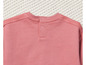 Un sweat-shirt rose avec des boutons dans le dos.