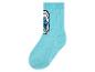 Une chaussette bleu clair avec un motif de Schtroumpfs.