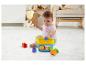 Bébé joue au sol avec un jouet de tri de formes Mattel Fisher-Price.