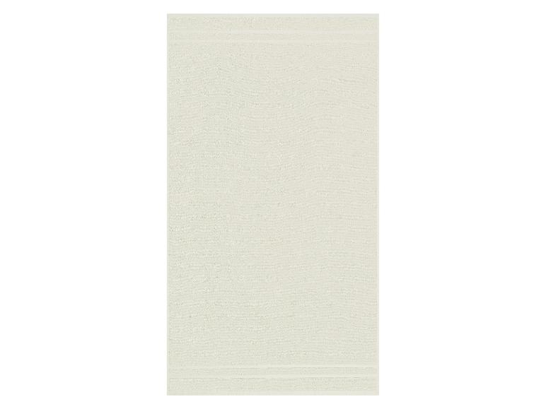 Une serviette de bain lisse de couleur vert clair.