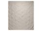 Couverture beige avec un motif de feuilles en relief.
