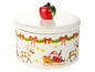 Une boîte à gâteau de Noël blanche avec une pomme rouge sur le couvercle et le Père Noël dans un traîneau avec des rennes.