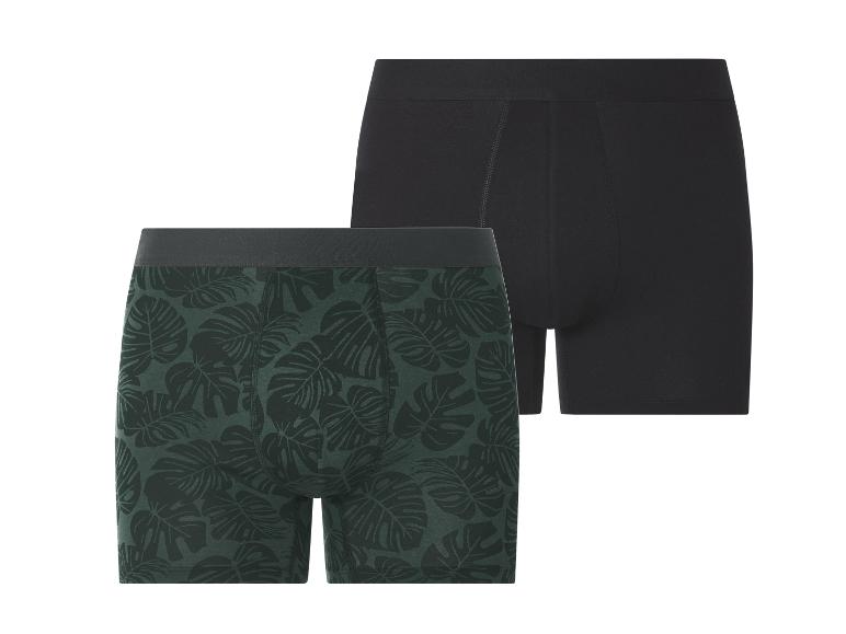 Deux boxers pour hommes: un noir et un vert foncé avec un imprimé feuilles.