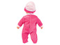 Une poupée bébé rose avec un bonnet