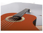 Une guitare acoustique orange avec une rosace ornée.