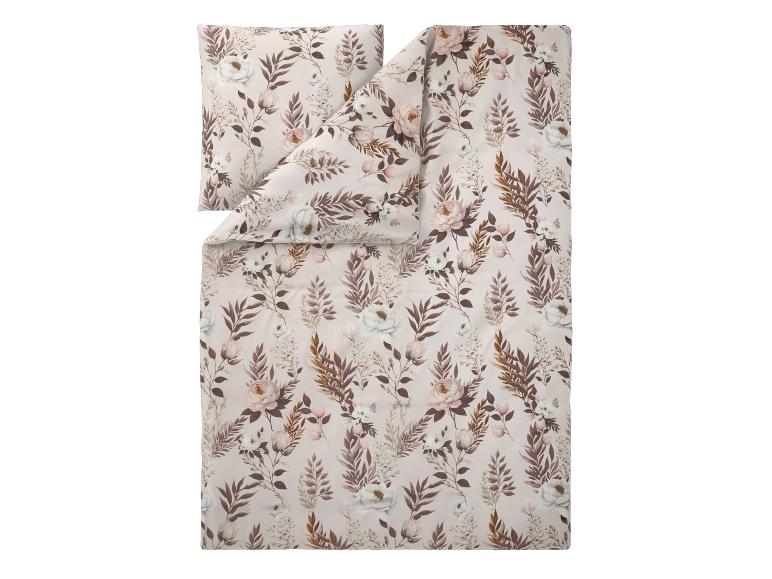 Parure de lit florale avec taie d'oreiller dans des tons rose, blanc et marron doux.