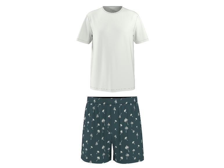 T-shirt blanc et short de pyjama vert foncé à motif de palmiers.