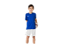 Un garçon souriant portant un maillot bleu et un short blanc de foot.