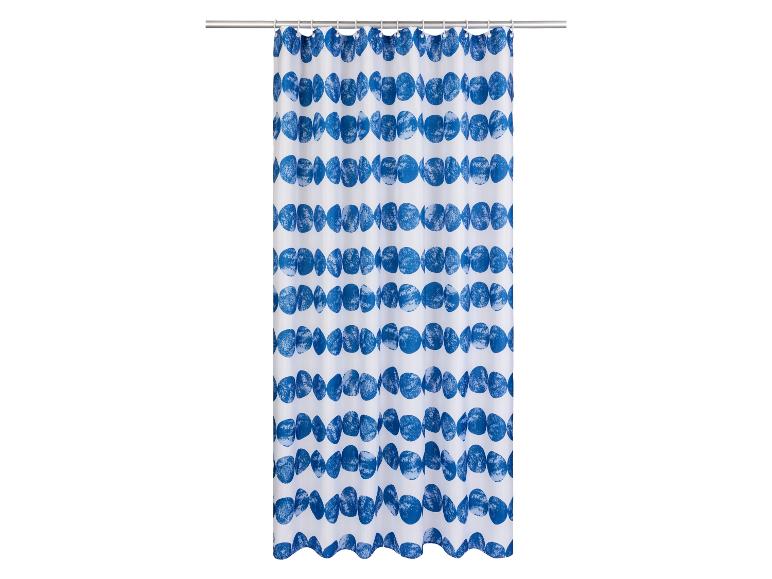 Un rideau de douche blanc avec des motifs ronds bleus.