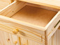 Un tiroir ouvert d'une armoire en bois avec une poignée ronde.