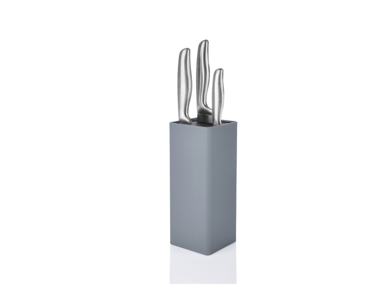 Un bloc à couteaux gris avec trois couteaux.