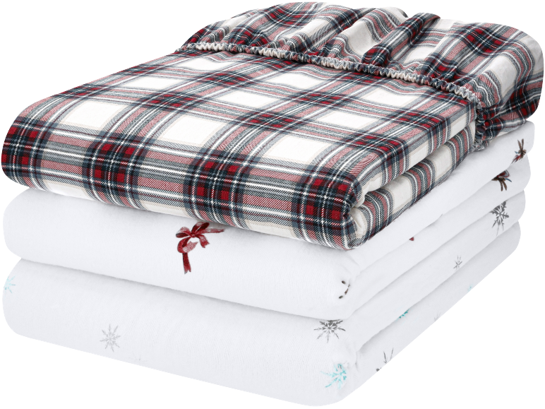 Parure de lit pliée à carreaux rouges et blancs et draps blancs à motifs de Noël.