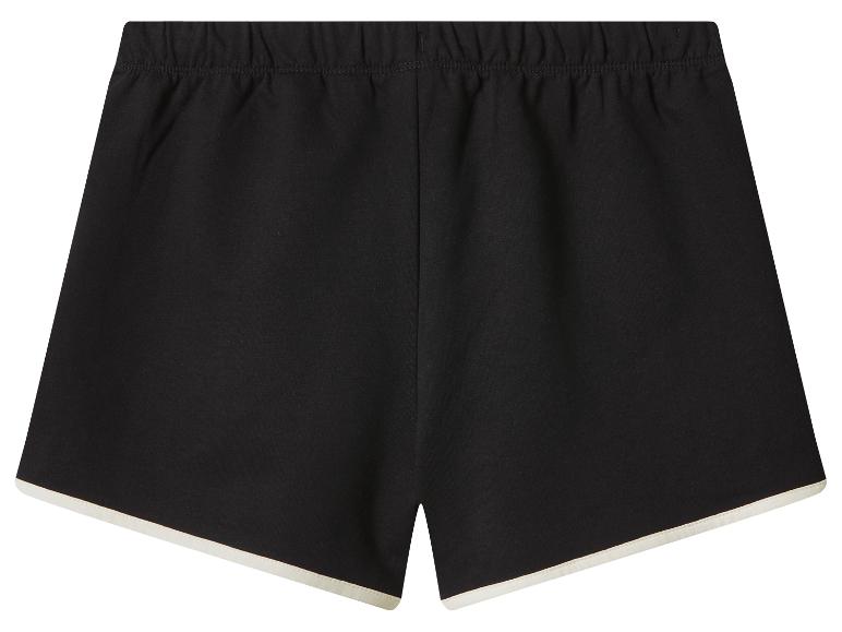Short de sport noir pour femme avec liseré blanc et taille élastique.