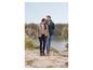 Un homme et une femme en vestes d'hiver marchent le long d'un lac.