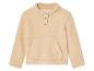 Un sweat en polaire crème avec des manches longues et un bouton.