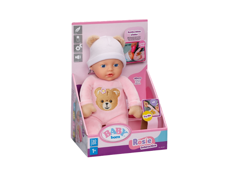 Poupée bébé interactive en pyjama et bonnet roses dans sa boîte.