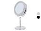 Miroir de maquillage rond chromé avec éclairage LED et base stable.