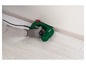 Une agrafeuse Parkside verte est utilisée pour fixer une plinthe en bois.