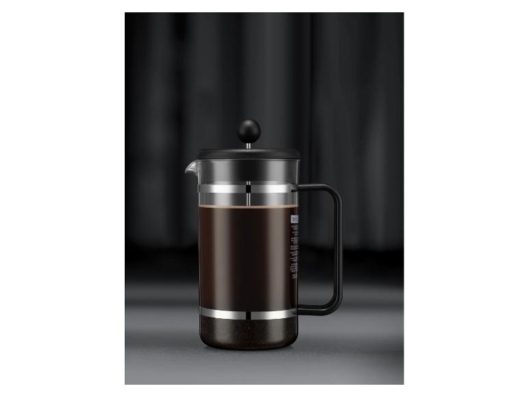 Cafetière à piston avec café sur fond sombre