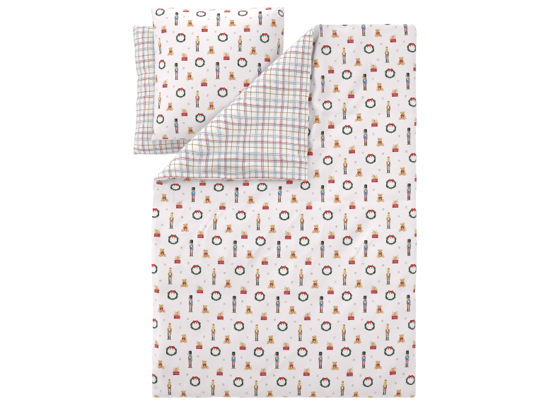 Parure de lit réversible pour enfants avec motifs de Noël et envers à carreaux.