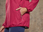 Une veste de pluie rose avec une poche.