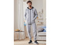 Homme portant un sweat à capuche et un pantalon de jogging gris de Puma.