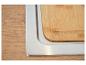 Planche à découper en bois dans un évier en acier inoxydable, sur une surface en bois.