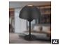 Lampe de table noire avec abat-jour en dôme, base ronde et cordon, sur fond flou.