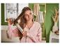 Une femme utilise une brosse pour coiffer ses cheveux.