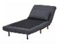 Fauteuil convertible gris foncé avec coussin.