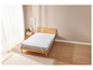 Un protège-matelas blanc sur un cadre de lit en bois dans une chambre à coucher.