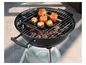 Tomates et champignons farcis sur un barbecue noir.
