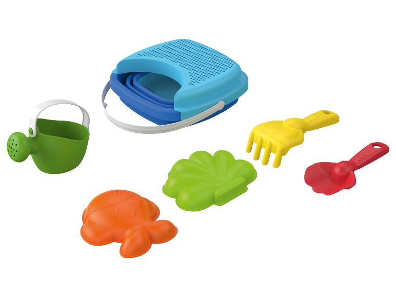 Un seau bleu, un arrosoir et des moules à sable pour enfants.