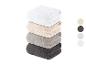 Pile de serviettes de bain en blanc, beige, gris et noir.