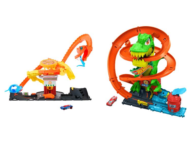 Deux ensembles de jeu Hot Wheels sur le thème des dinosaures et des serpents, avec pistes et voitures.