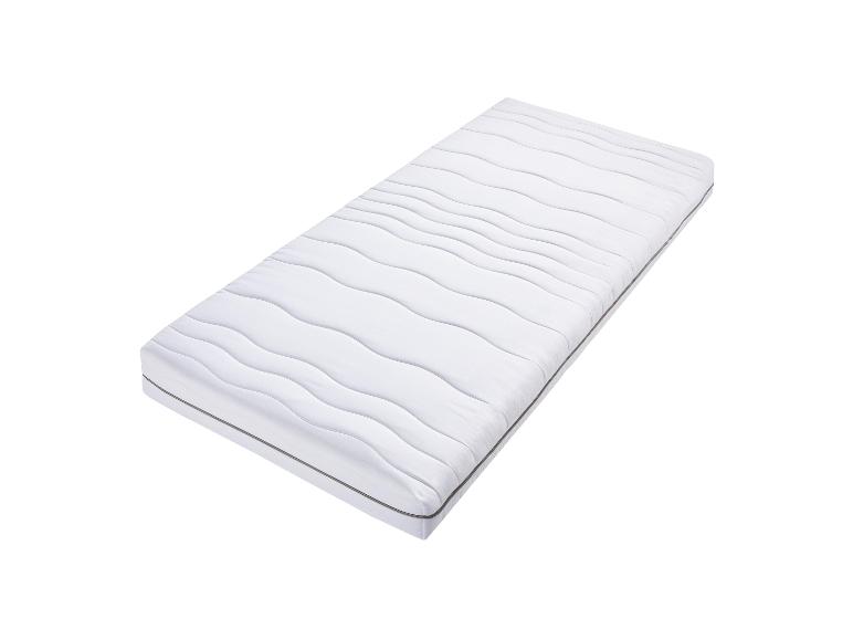 Un matelas blanc avec un motif ondulé.