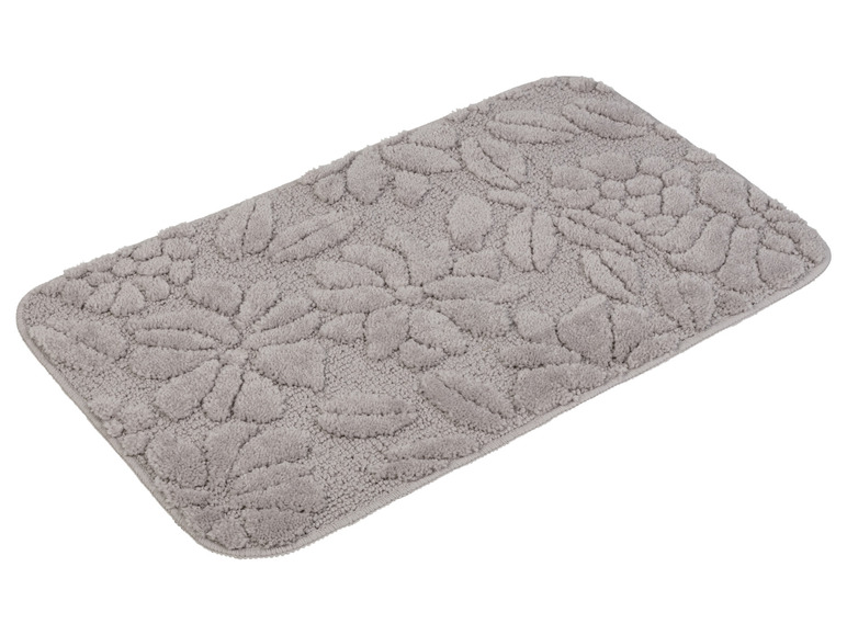 Un tapis de bain gris avec un motif floral.
