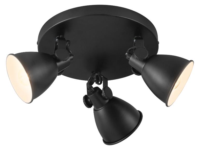 Plafonnier noir avec trois spots réglables, éclairés d'une lumière chaude.