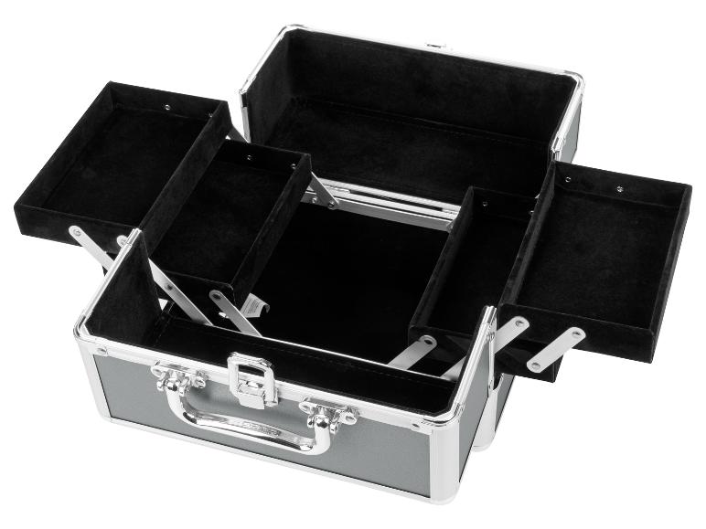Une trousse de maquillage en aluminium ouverte avec un intérieur en velours noir.