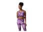 Femme en brassière de sport et leggings à motif abstrait violet.