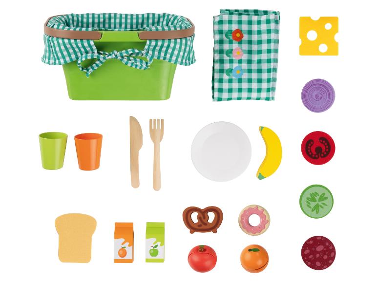 Panier de pique-nique jouet avec nourriture et vaisselle.