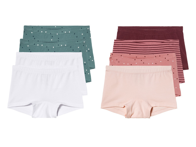 Un ensemble de sous-vêtements avec des culottes blanches, vertes et roses.