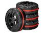 Quatre housses de pneus noires Ultimate Speed avec sangles rouges, une inclinée.