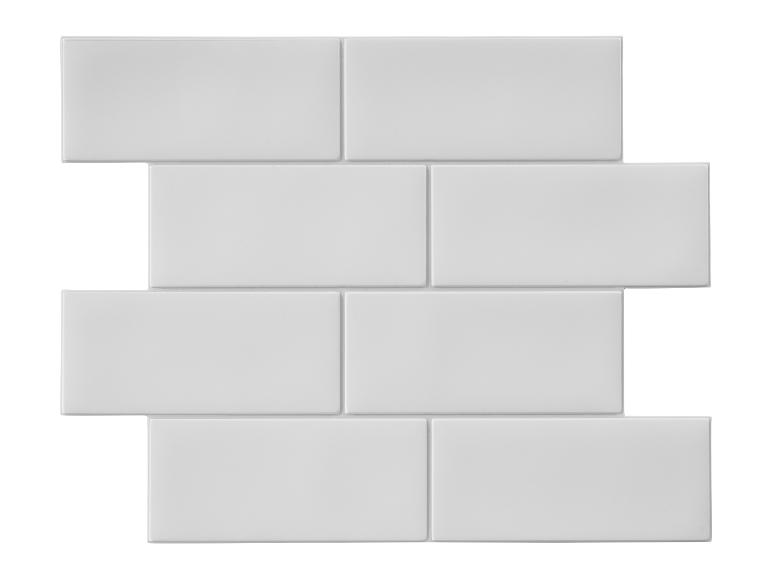 Carreaux blancs rectangulaires disposés en motif de brique.