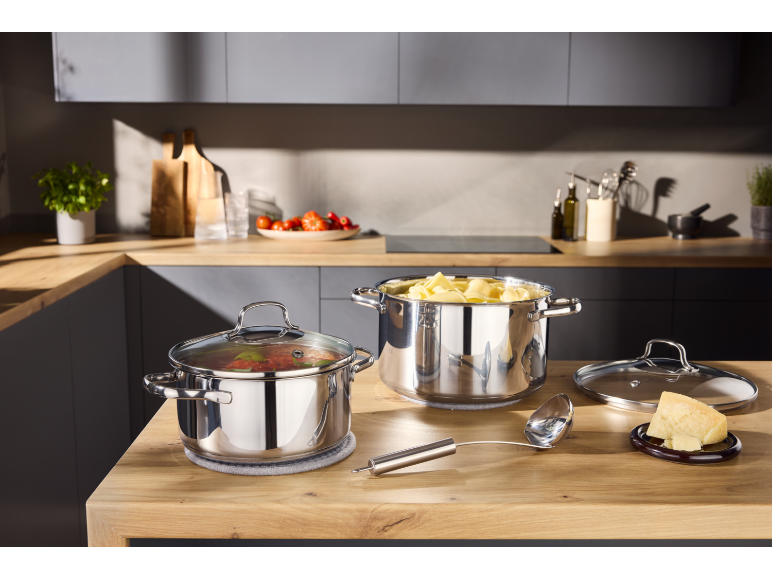 Casseroles en acier inoxydable avec des pâtes et de la sauce dans la cuisine.