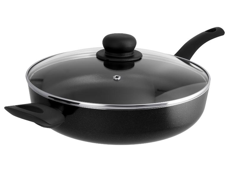 Wok noir antiadhésif avec couvercle en verre et deux poignées sur fond blanc.