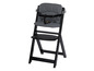 Une chaise haute Stokke Tripp Trapp noire avec un motif géométrique noir et blanc.