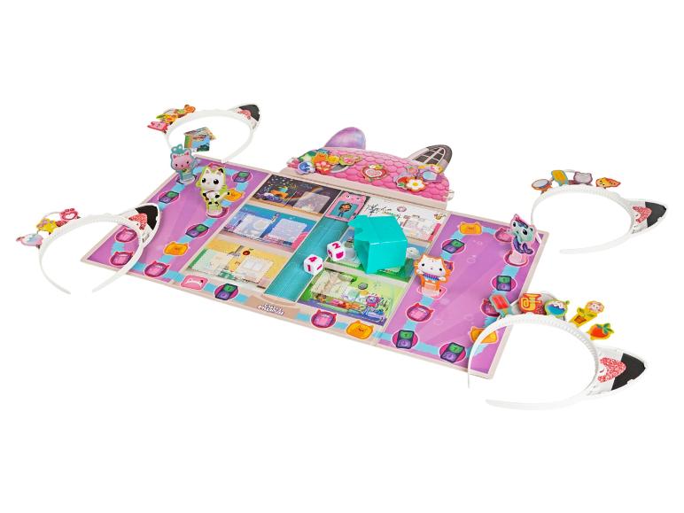 Un jeu de société sur le thème des chats, avec une maison de poupée et des bandeaux avec des oreilles de chat.
