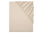 Un drap housse beige avec élastique.